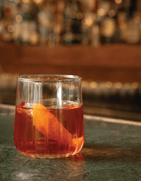 Classic Negroni in a whiskey tumbler with a orange peel