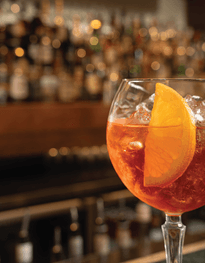 Negroni in a gin glass with a orange wedge